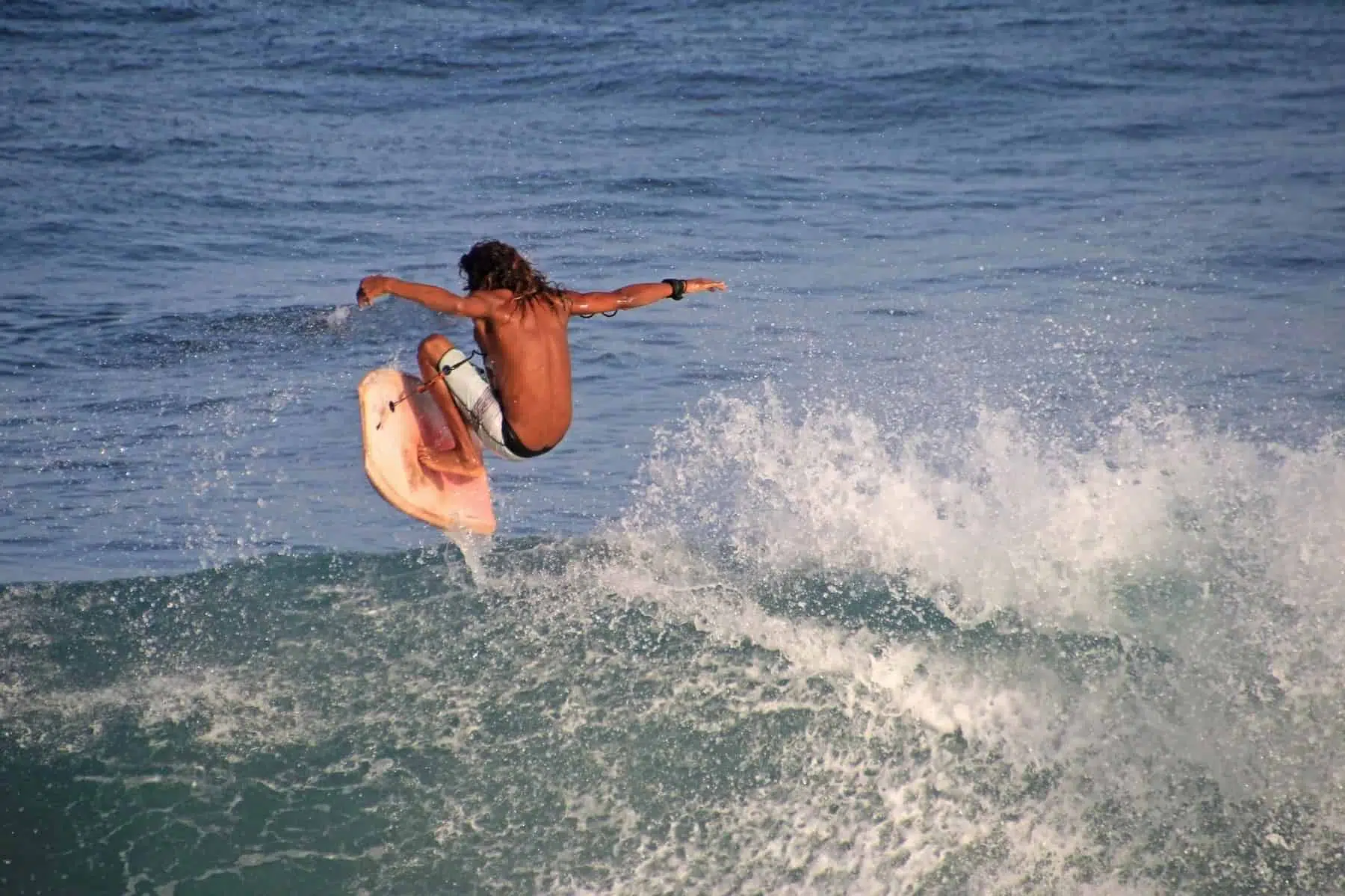 Matchless boogie boarder standing on the board and surfing, El Zonte beach, El Salvador, Central America