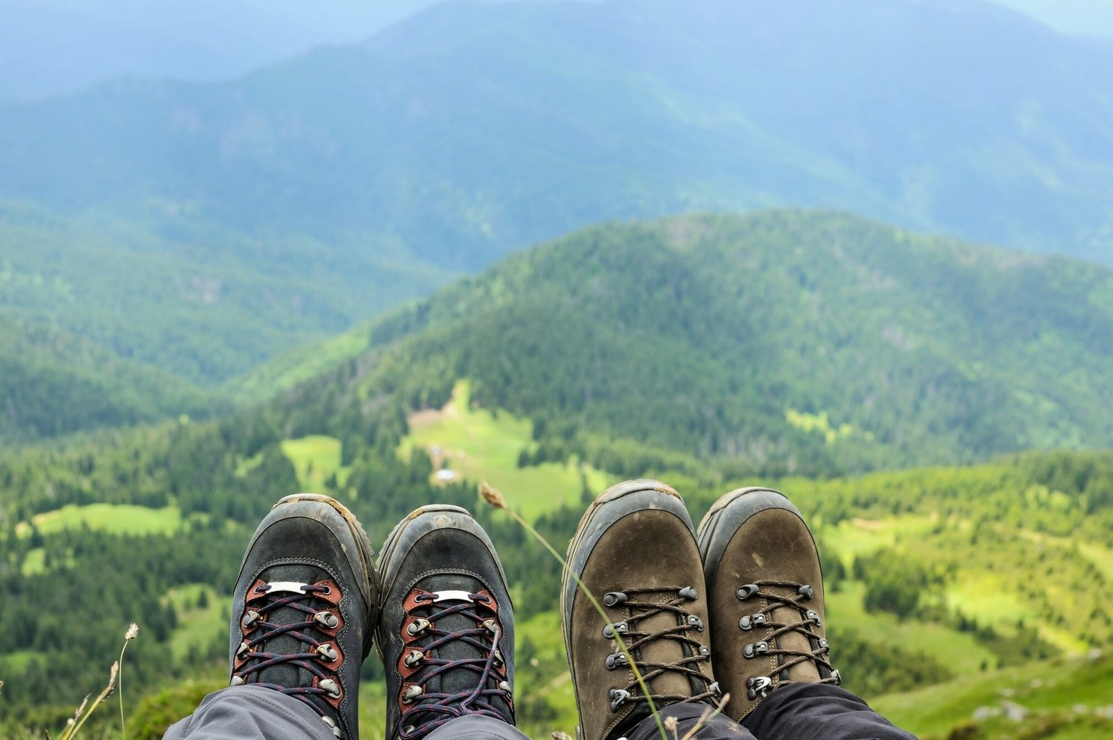 Hiking boots of traveler sitting on high mountain top