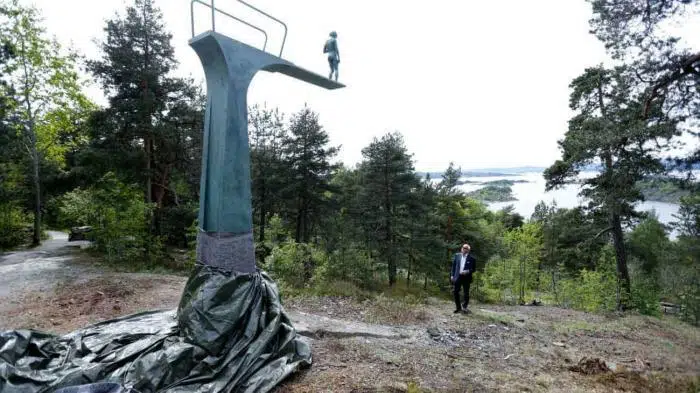 Mysterious woman sculpture with children in forest, outdoor art installation for nature-themed travel attractions.