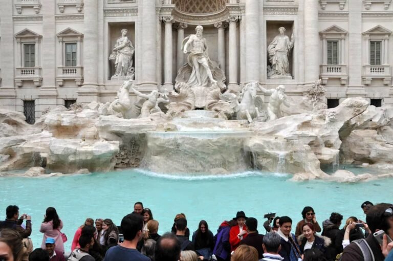 Tourists visiting Trevi Fountain Fontana di Trevi in city of Rome