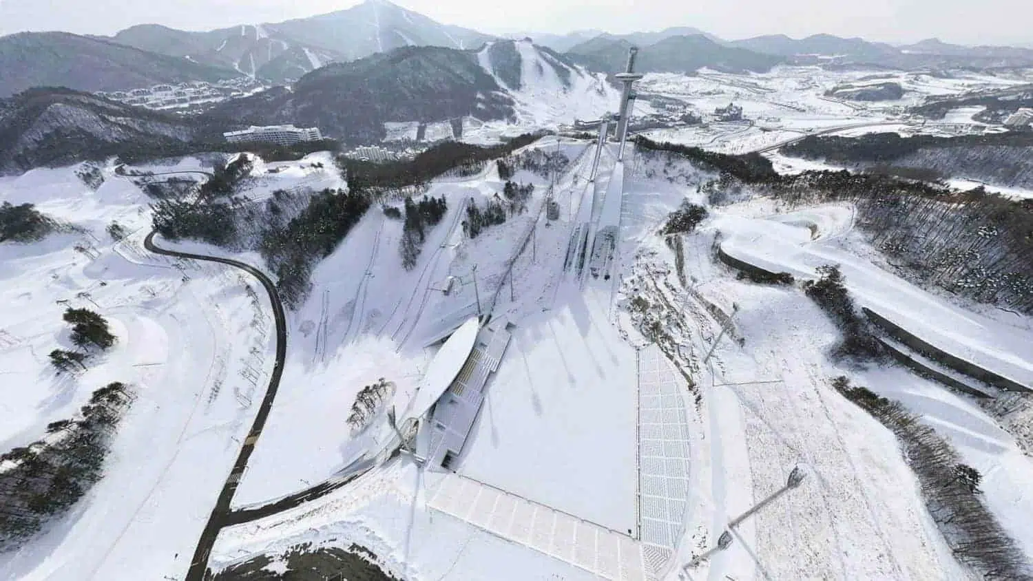 winter olympics south korea — Snow-covered traditional Chinese gate in a winter park scene.