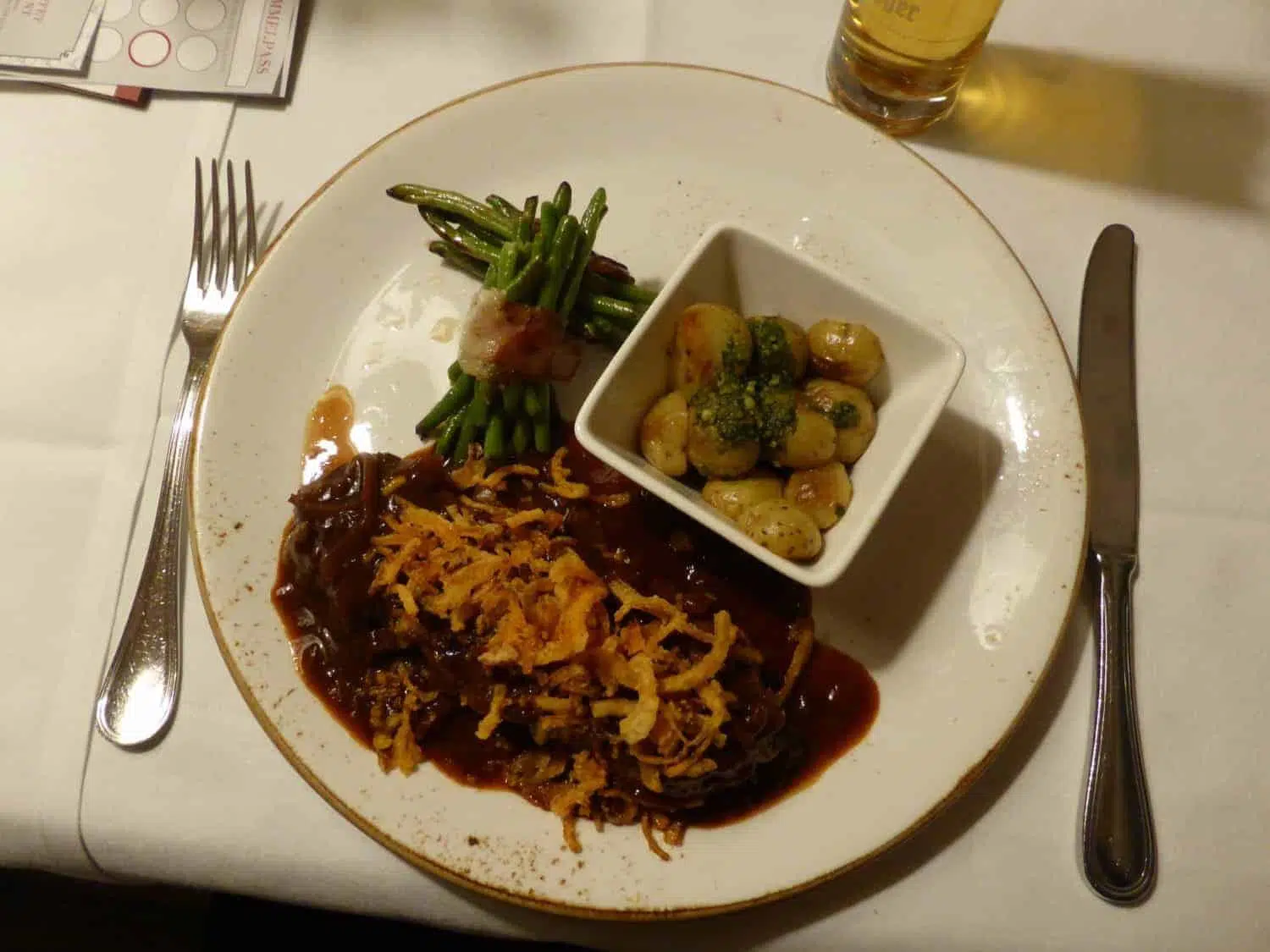 Delicious traditional German food with schnitzel, mashed potatoes, and roast meats at a restaurant.