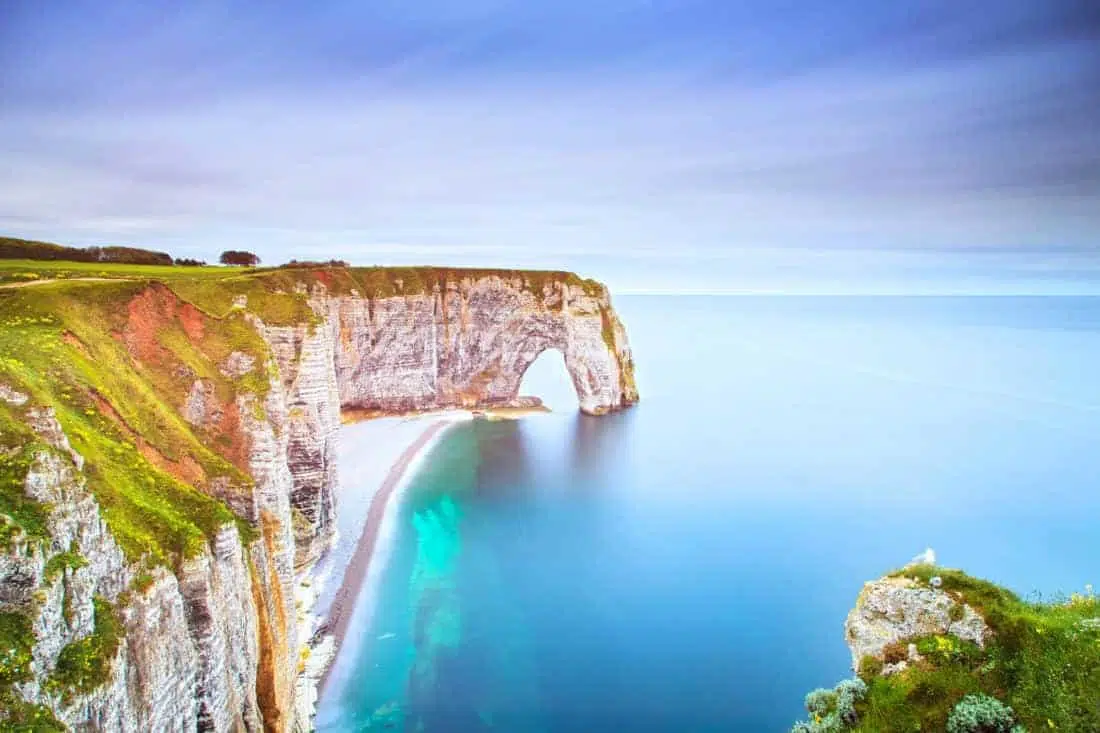 Etretat, la Manneporte natural rock arch wonder, cliff and beach. Long exposure photography. Normandy, France.