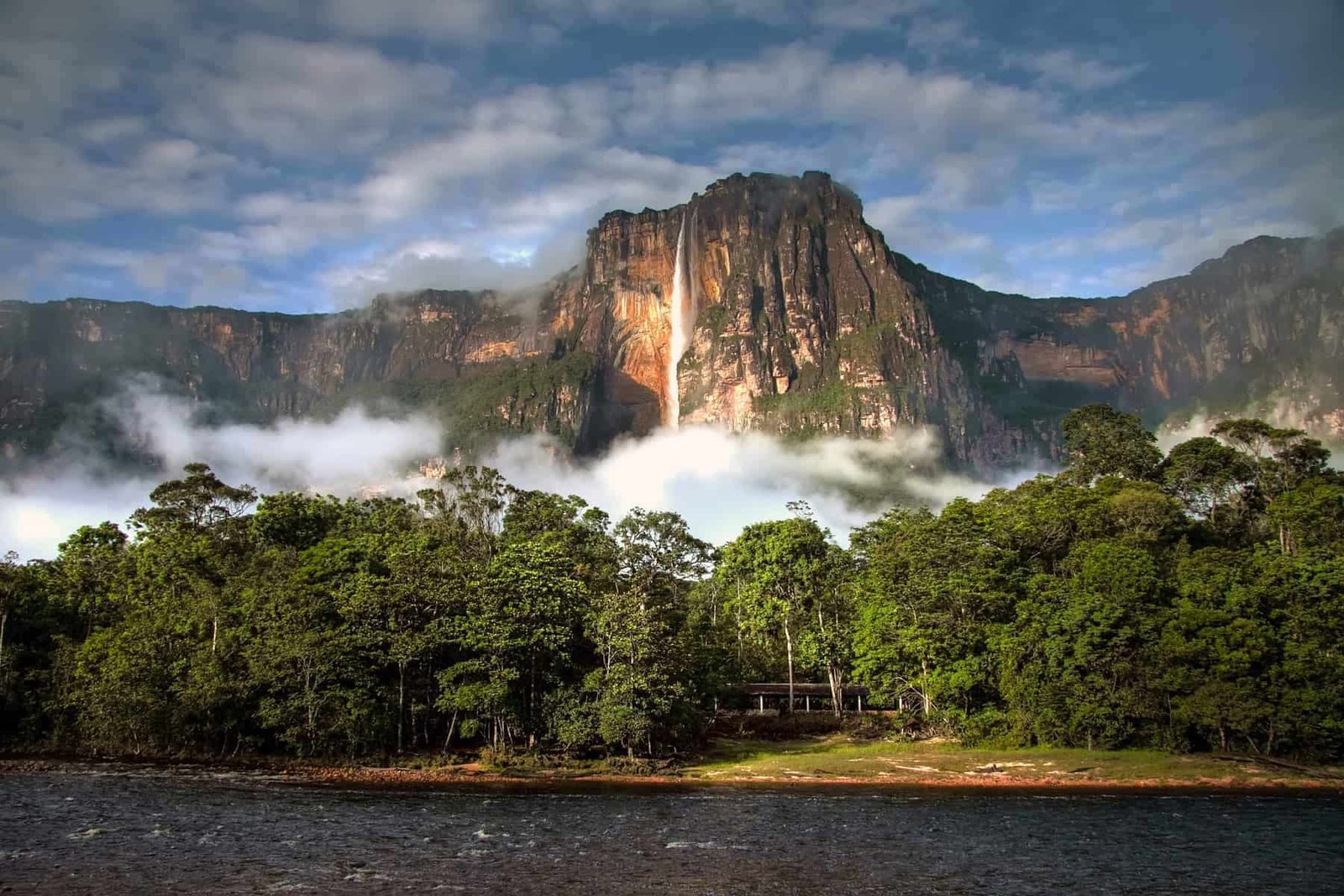 Majestic mountain with waterfall and lush greenery, perfect for nature travel adventures.