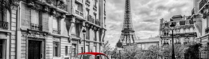 Holidays in France, Artistic Paris, France. Eiffel Tower seen from the street with red retro limousine car. Black and white unique vintage composition.