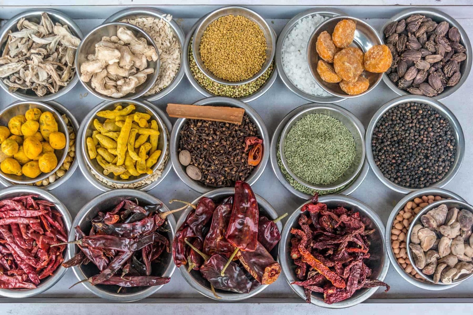 A top view of bowls filled with spices at a vendors stall in the largest spice market in Asia, the Khari Baoli section of Old Delhi, India.