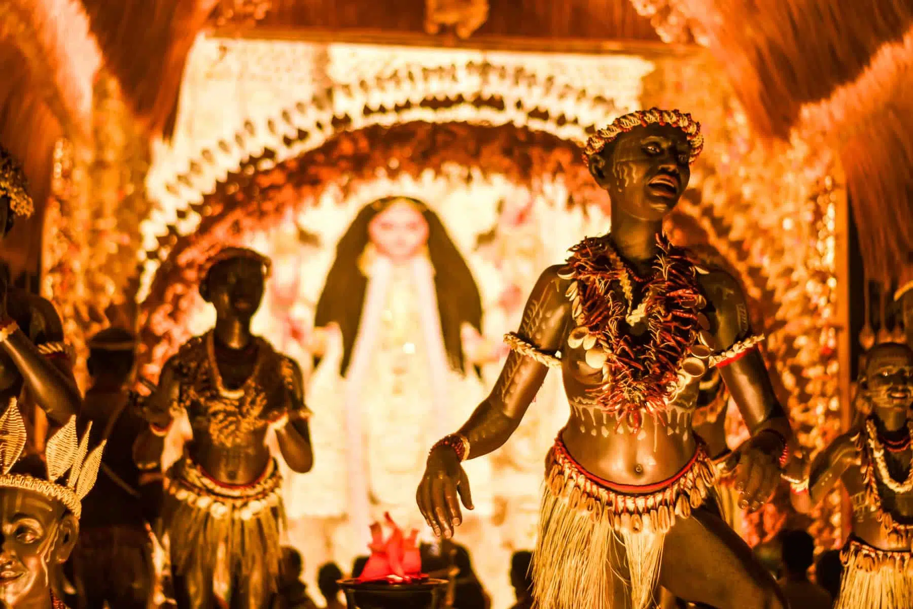 KOLKATA , INDIA SEPTEMBER 26, 2017 - Decorated art and craft sculptures of Traditional tribal Santal or Santhal ethnic group dancers wear traditional clothing in a famous Durga Puja pandal.