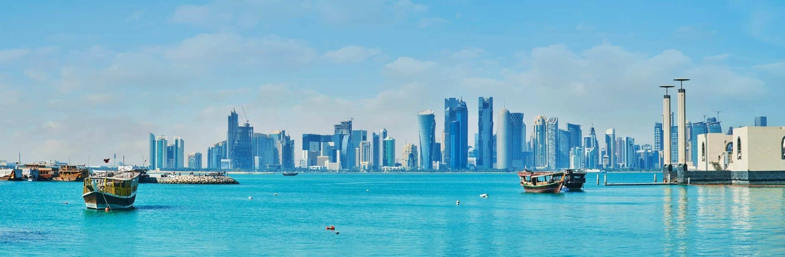 The seaside view on futuristic skyscrapers of West Bay from the Corniche promenade, Doha, Qatar.