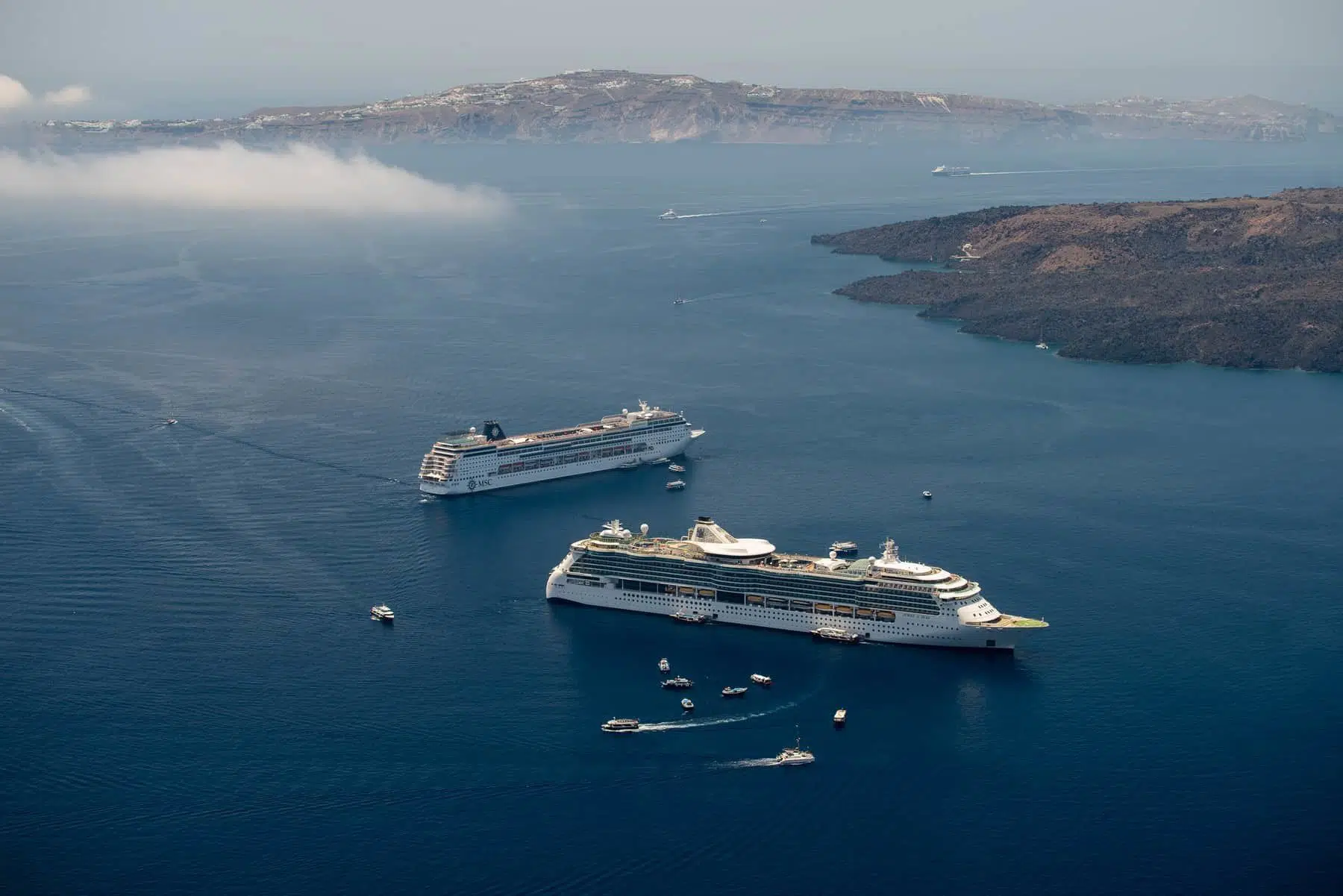 Cruising ship on Santorini island in summer time on Aegean sea.