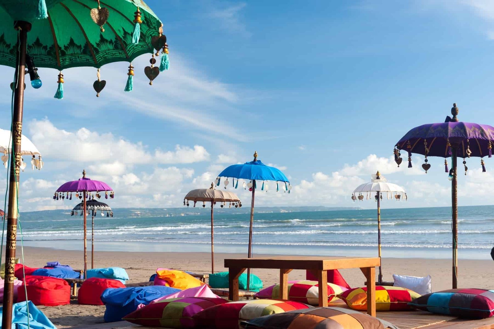 This image shows some colourful beach umbreallas and pillows in Kuta, Bali