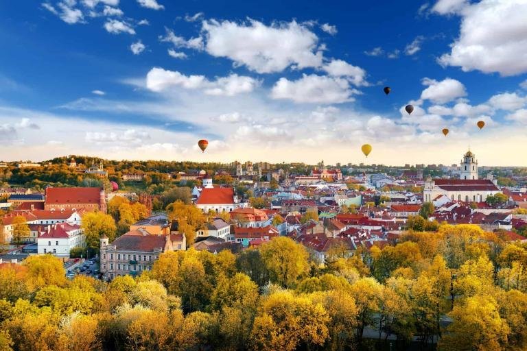 The Baltic region, Beautiful autumn panorama of Vilnius old town with colorful hot air balloons in the sky, taken from the Gediminas hill