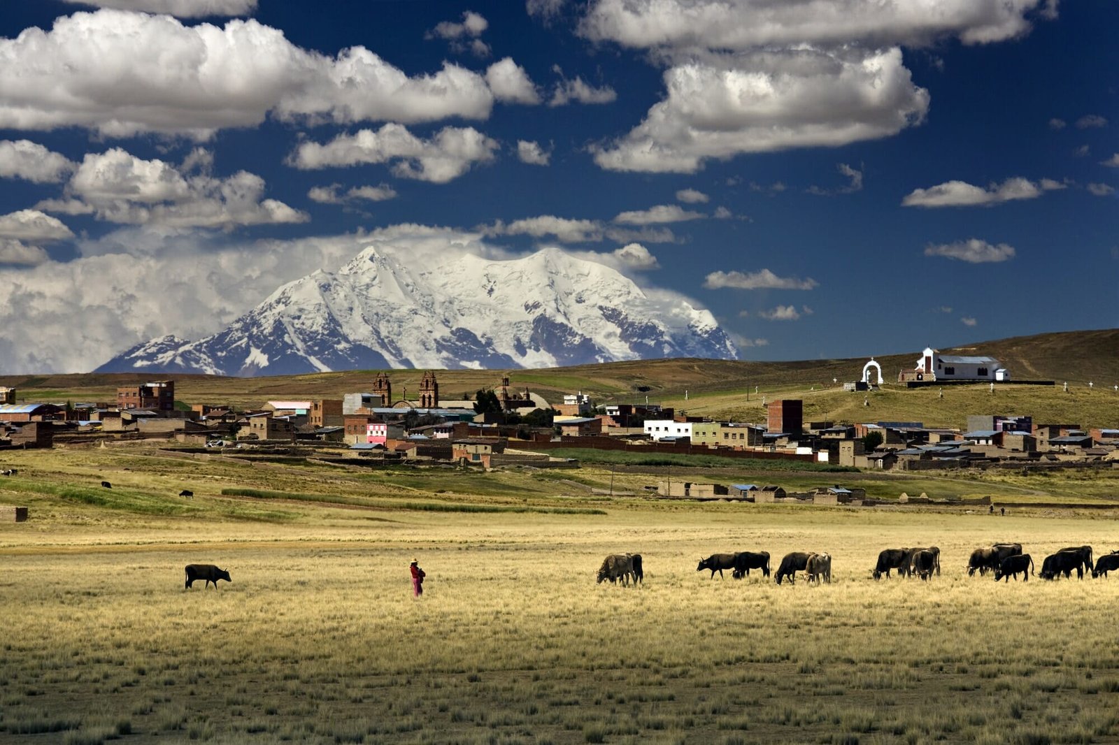 Bolivia: Illimani Mountain (6100m) and village (3800m) on the altiplano near La Paz