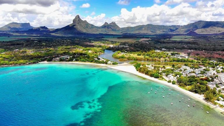 Go to Mauritius. Blue lagoon and mountains, aerial view from helicopter. Mauritius Island. Indian Ocean.