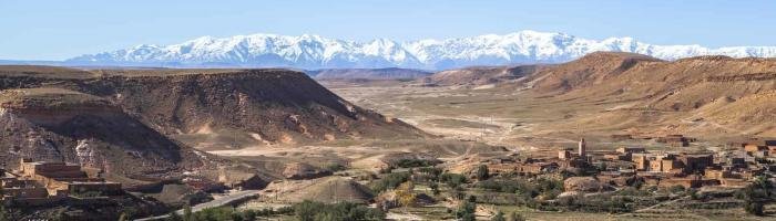 The Atlas Mountains is a mountain range which stretches across northwestern Africa extending about 2,500 km (1,600 mi) through Algeria, Morocco and Tunisia. The highest peak is Jebel Toubkal, with an elevation of 4,167 metres (13,671 ft) in southwestern Morocco. The Atlas ranges separate the Mediterranean and Atlantic coastlines from the Sahara Desert. The population of the Atlas Mountains is mainly Berbers. The terms for 'mountain' in some Berber languages are adrar and adras, believed to be cognate with the toponym.