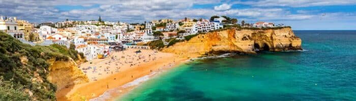 View of Carvoeiro fishing village with beautiful beach, Algarve, Portugal. View of beach in Carvoeiro town with colorful houses on coast of Portugal. The village Carvoeiro in the Algarve Portugal.