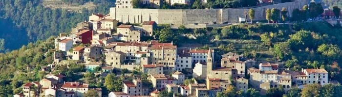 Picturesque hillside village with historic castle and colorful houses in Tuscany, Italy.