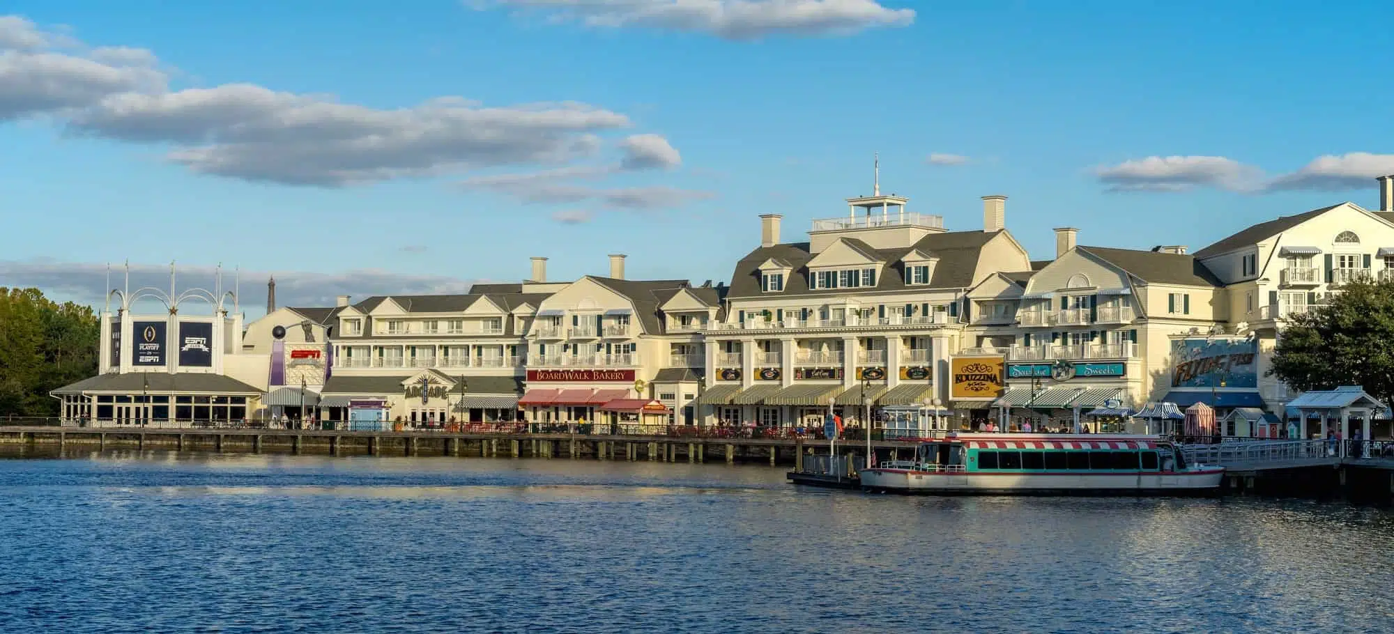 Waterside resort with shops and boats at a scenic seaside destination for vacation travel.