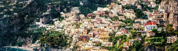 Colorful coastal town nestled on steep hillside overlooking the Mediterranean Sea.
