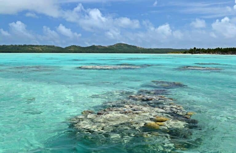The colorful Aitutaki lagoon spotted by coral reef, in the middle of the South Pacific Ocean Location Aitutaki atoll, Cook Islands
