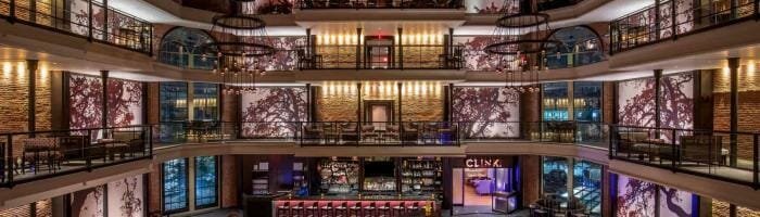 Luxury hotel lobby with modern design, elegant lighting, and spacious seating areas.