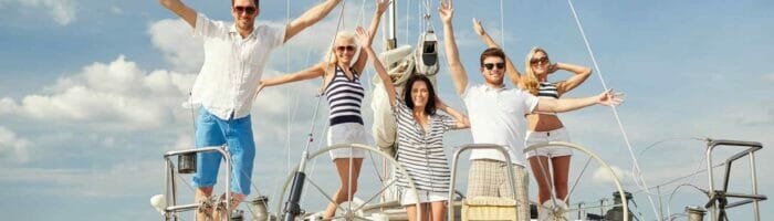 Sailing vacation in the Carribean smiling people onboard a yacht