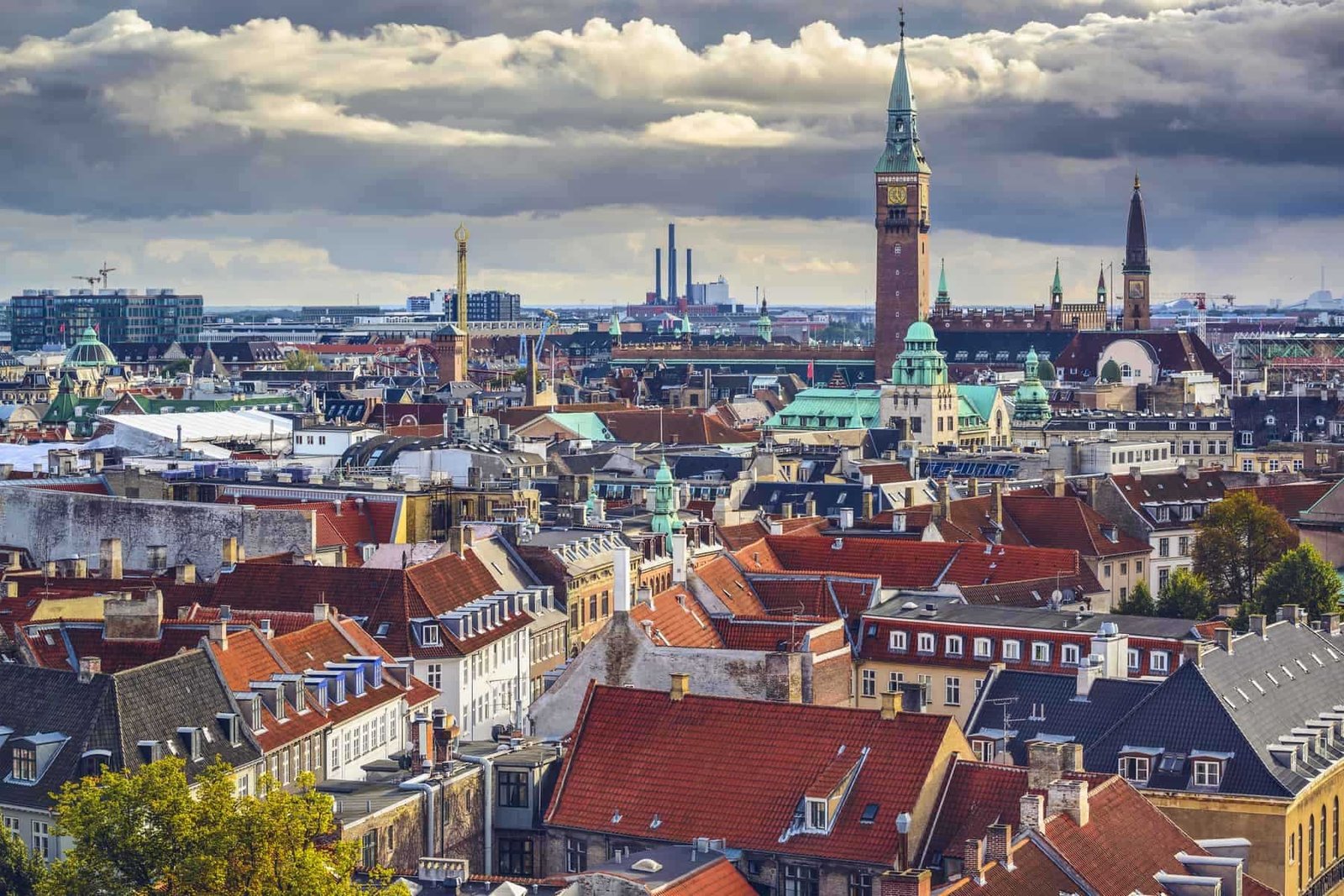 Vibrant cityscape of Munich with historic architecture and modern skyline during cloudy weather.