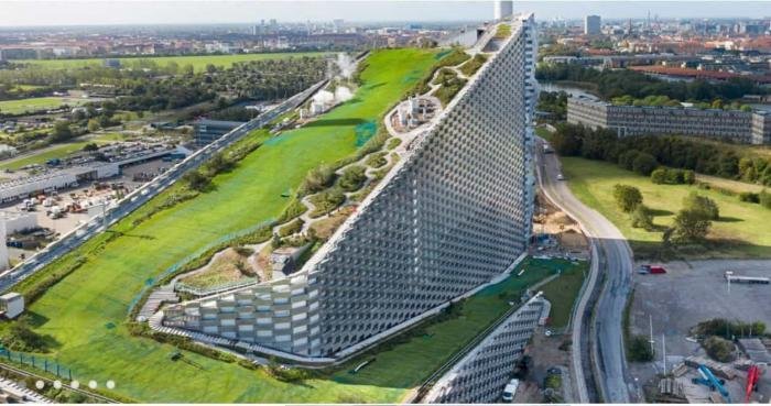 Eco-friendly hotel building with green rooftop gardens in an urban setting, promoting sustainable tourism.