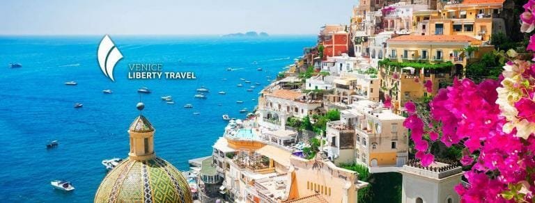 Colorful cliffside houses in Positano with the Mediterranean Sea in the background, vibrant flowers, and luxury travel scene.