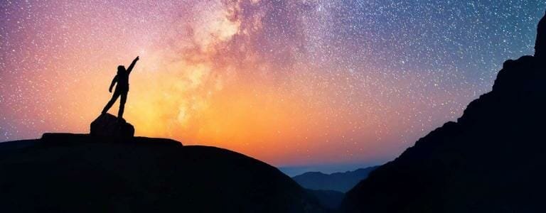 Vast starry night sky over mountain silhouette, stargazing, adventure, travel, nature, outdoor exploration, scenic landscape.