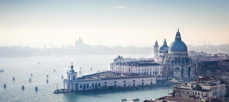 Historic Venice skyline with domed churches and scenic waterfront views, perfect for travel and vacation enthusiasts.