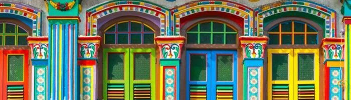 Vibrant colorful house exterior with intricate Mexican folk art design and architecture.