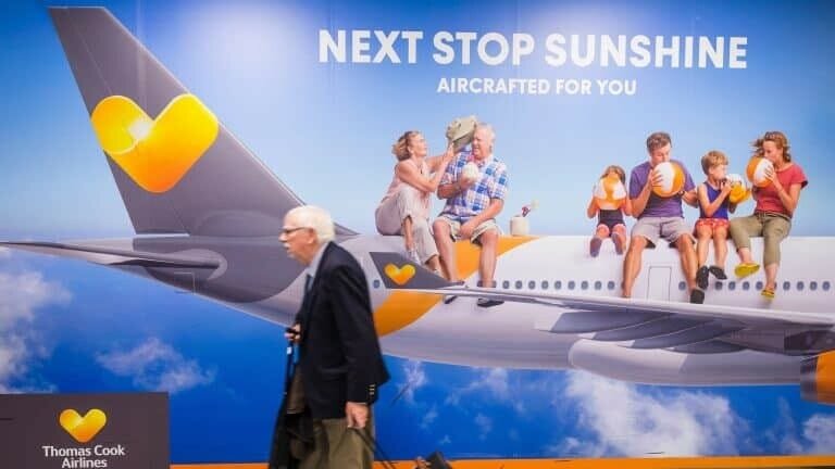 Bright Thomas Cook Airlines advertisement with family and children relaxing on airplane wing, emphasizing travel and vacation experiences.