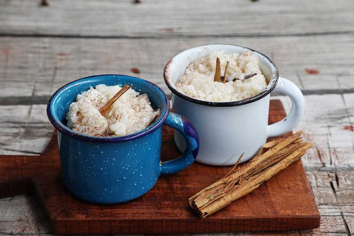 Scented couscous with dried fruits, cinnamon sticks, and star anise in traditional Moroccan pottery.