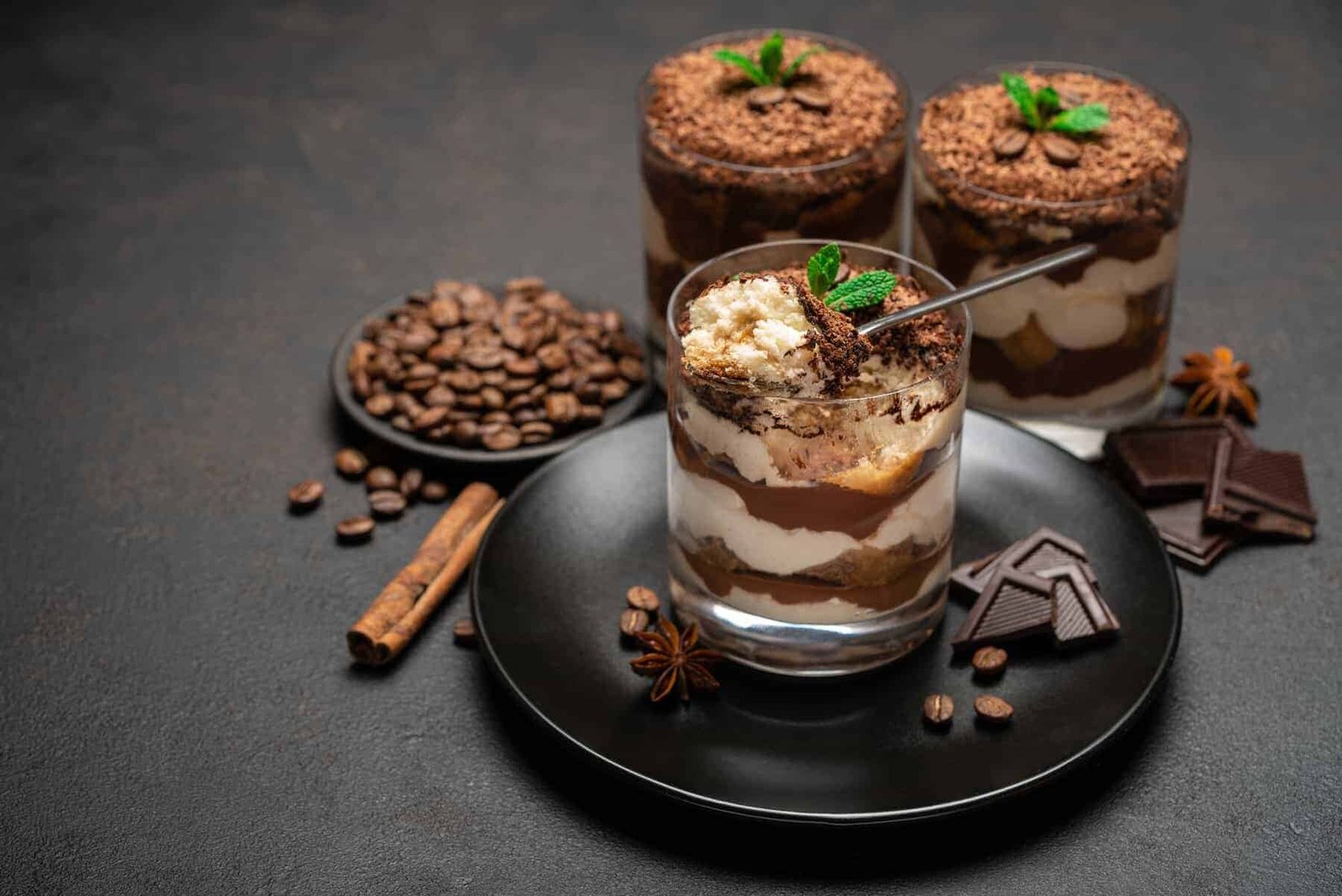 Creamy chocolate and cookies and cream ice cream scoops in a rustic wooden bowl.