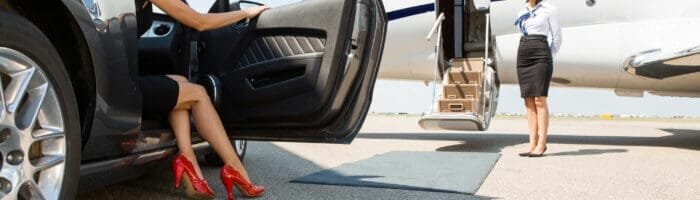 Luxury woman boarding private jet at airport, travel, business trip, corporate flight, executive travel.
