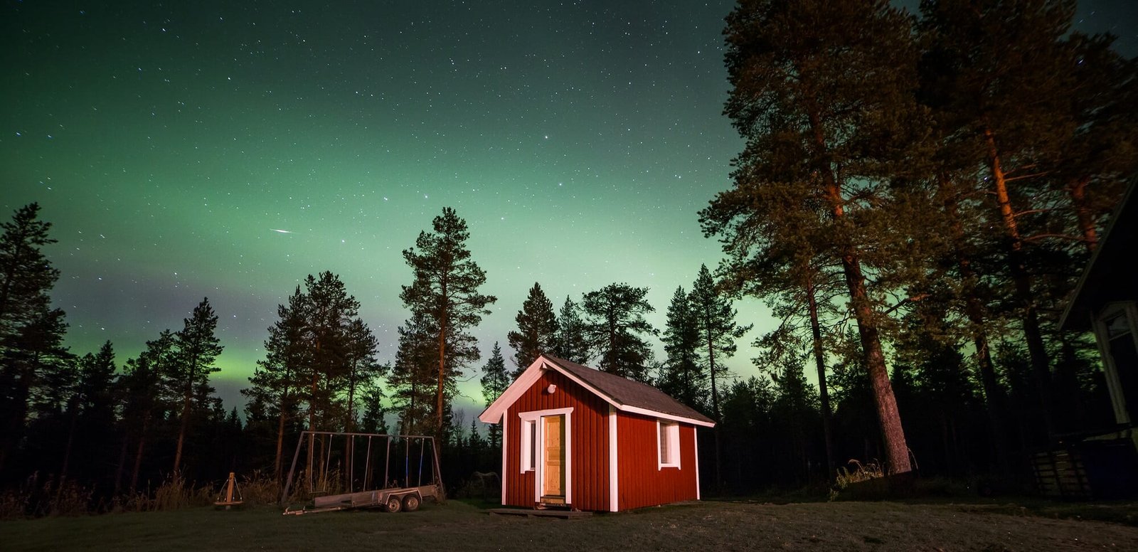 A beautiful green and red aurora dancing over Rovaniemi, Finland