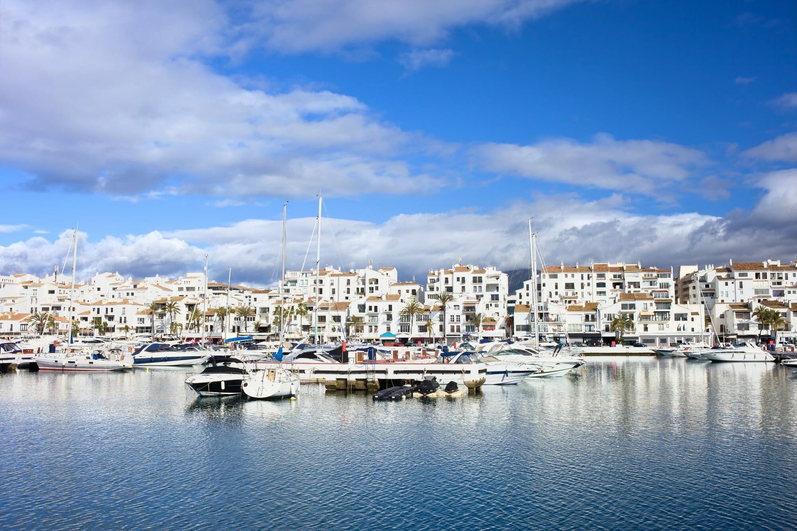 Marina waterfront with luxury motor yachts in holiday resort town of Puerto Banus on Costa del Sol, near Marbella in Spain, Malaga province.