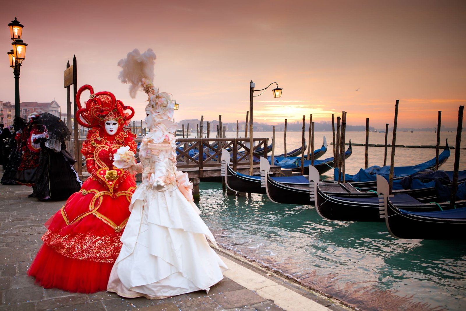 Beautiful costumed women in front of the Grand Canal Venice