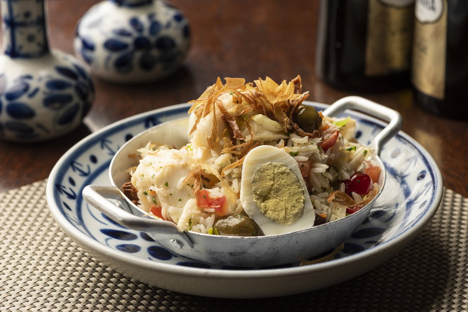 Cod fish bacalhau with rice, onions eggs olive oil - portuguese traditional food 
