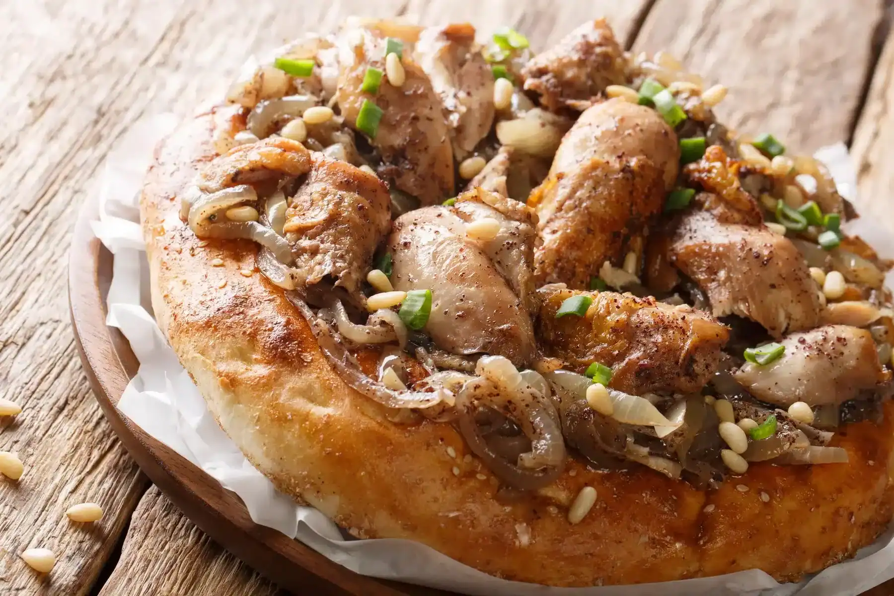 Chicken with sumac and onions served with taboo bread 