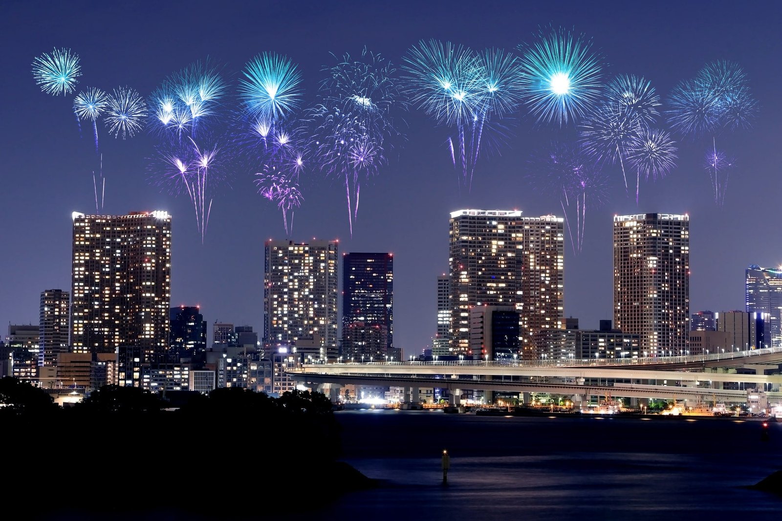 Fireworks celebrating over Odaiba, Tokyo cityscape at night