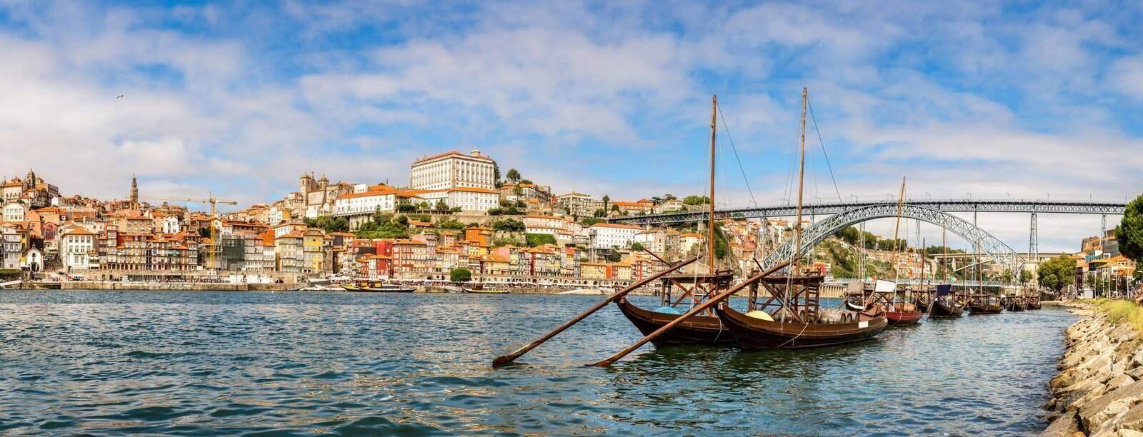 Visit Porto in Portugal, Porto and see old traditional boats with wine barrels in Portugal in a summer day