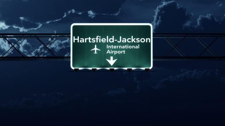 The busiest airports. Atlanta USA Airport Highway Sign at Night