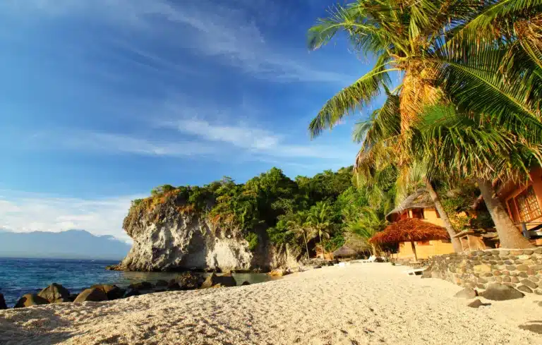 Sandy beach and palm trees in a small lagoon. Apo island, Philippines