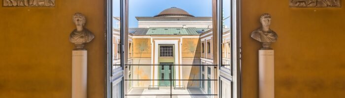 Open classical architecture balcony view with sculptures and murals, historic building design for travel enthusiasts.