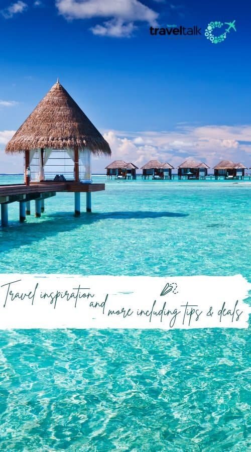Overwater bungalows in crystal-clear turquoise ocean waters under a blue sky, perfect tropical vacation destination.